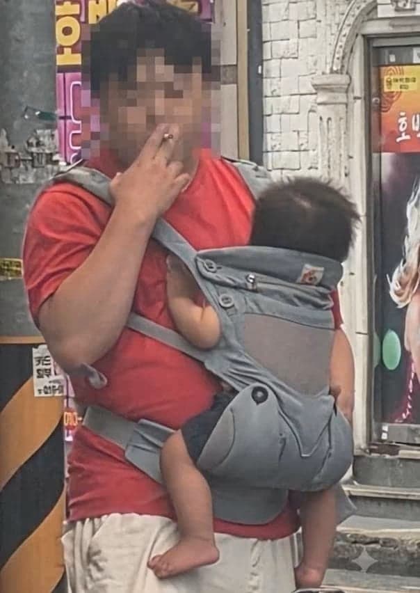 아기 안고 길거리서 담배 피우는 남성 포착…아동학대 논란 확산